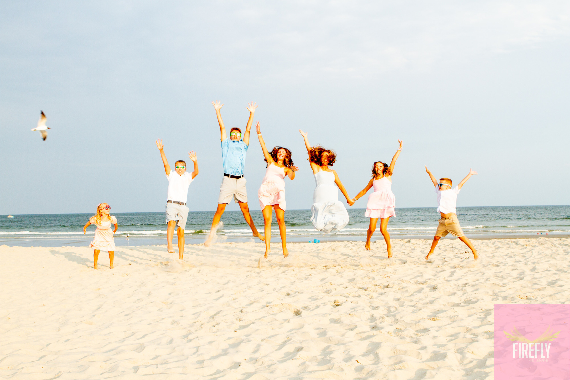 Cousins jumping in unison on the sand