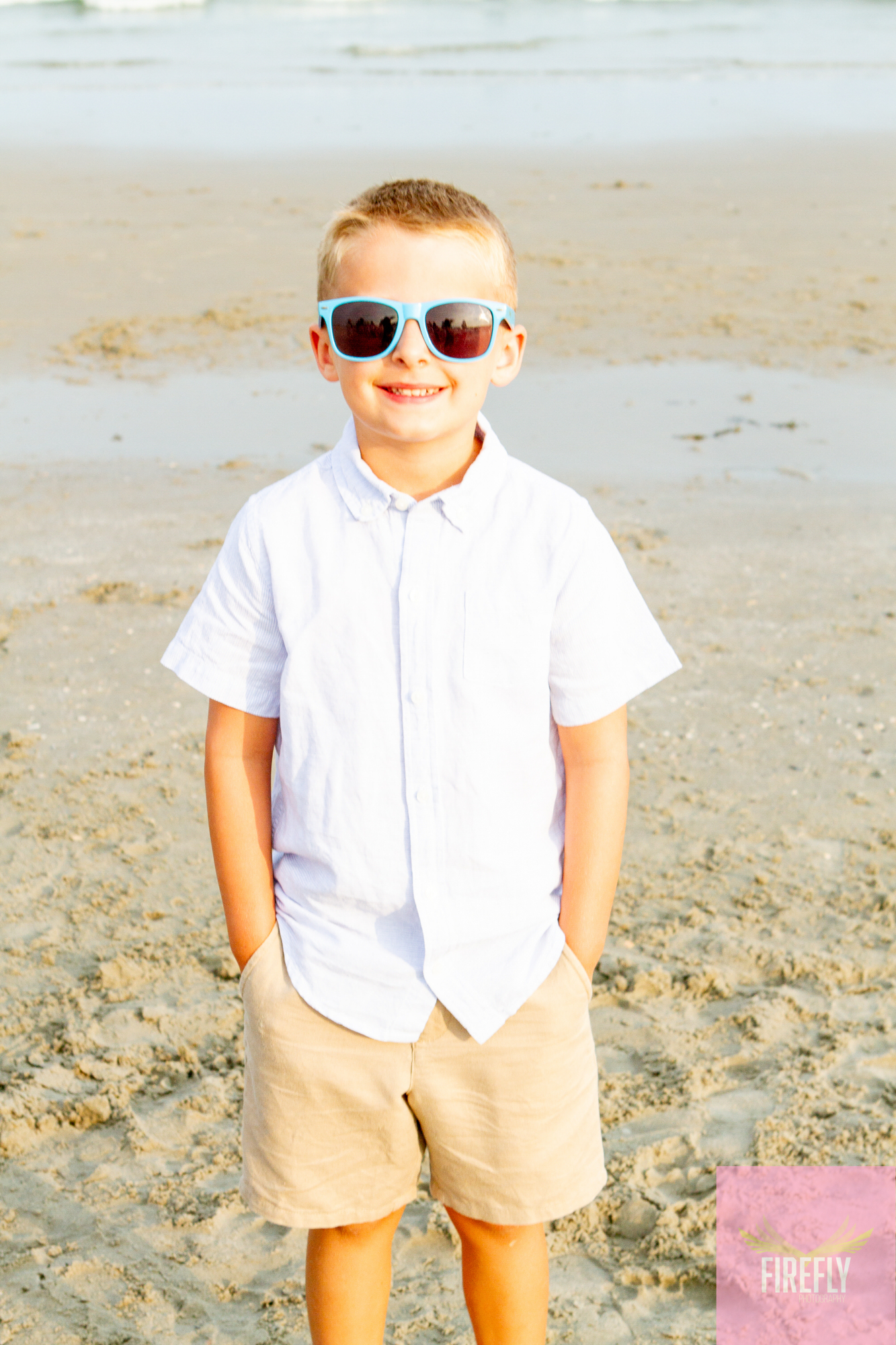Young boy in sunglasses on the beach